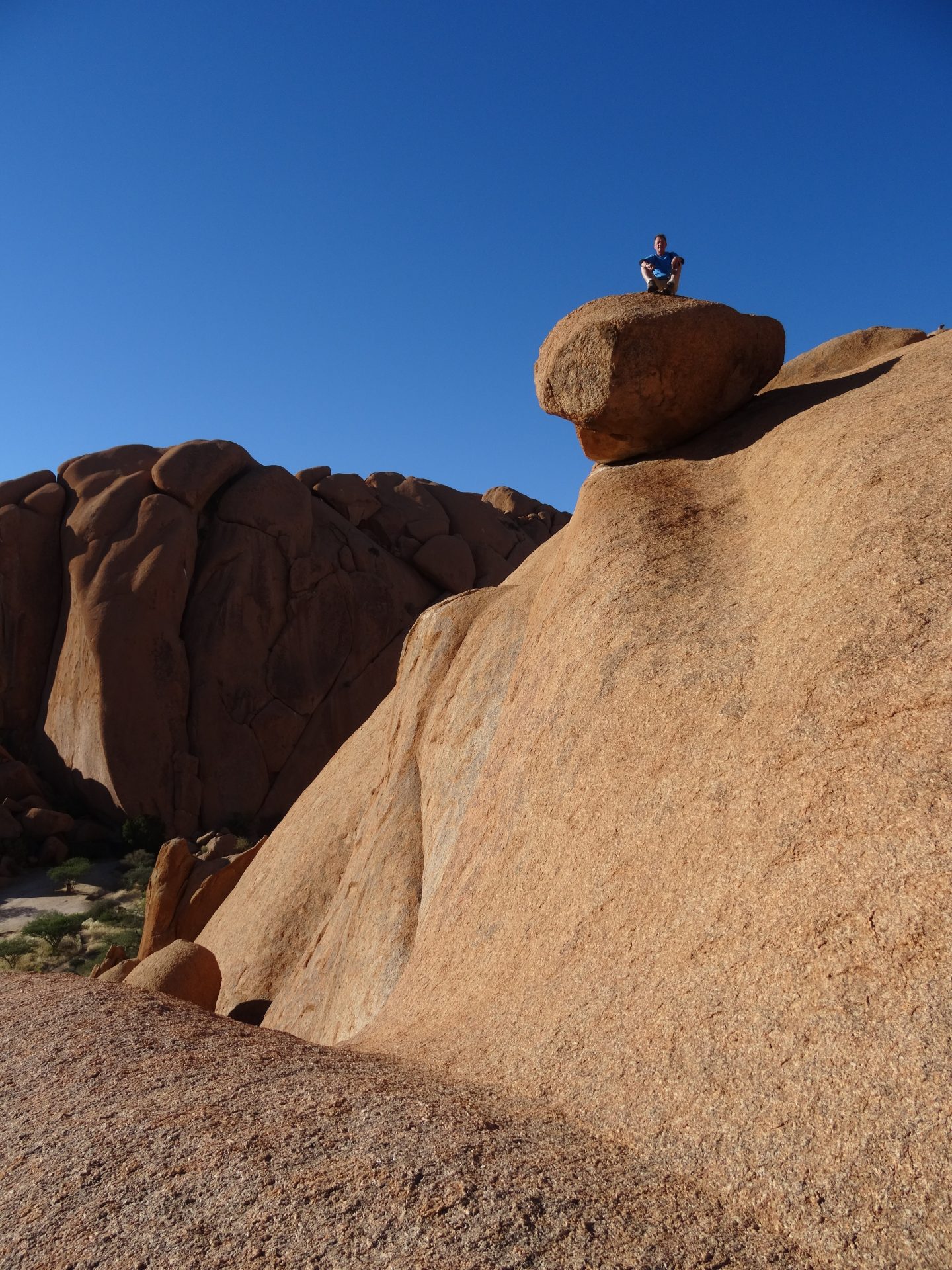 Armand Wadsworth atop a boulder Namibia